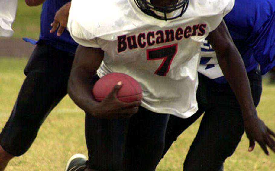 Kadena Buccaneers quarterback A.J. Morgan eludes the Kadena Islanders defense during Thursday&#39;s Okinawa Activities Council regular season-ending contest at Panthers Field, Kadena High School, Kadena Air Base, Okinawa.