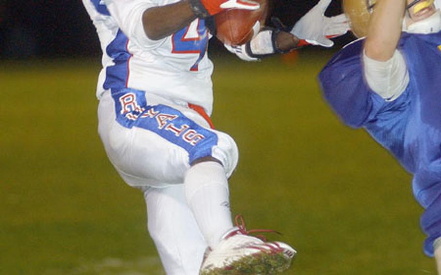Ramstein&#39;s Keeshawn Carr, left, makes a spectacular catch over a diving Jerry Kelly of Wiesbaden for a 26-yard gain late in the 3rd quarter of the DODDS Division I Football Championship game in Baumholder, Germany, on Saturday.