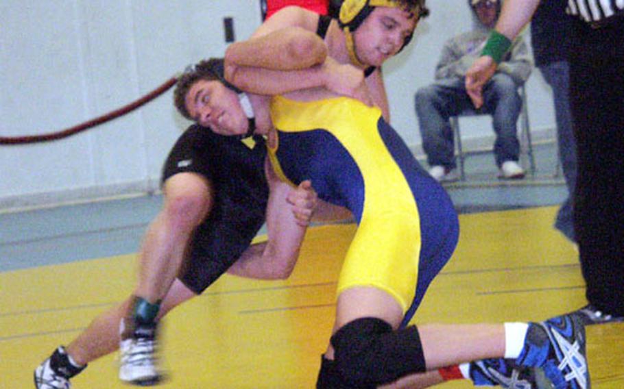 Patch&#39;s Mike Beukins, left, in black, attempts to take Wiesbaden&#39;s Ricky Gonzalez to the mat Saturday at the Ramstein Takedown Tournament for high school wrestlers. Gonzalez later pinned Beukins to take third place at 189 pounds in the unofficial, but DODDS-Europe-sanctioned, event.
