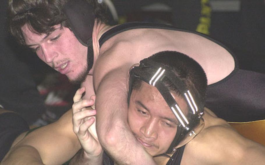 158-pounder Josh Phillips of the Kadena Panthers gets the upper hand on Chris David the Kubasaki Dragons during Friday&#39;s Okinawa Activities Council season-opening wrestling dual meet at Kubasaki High School, Camp Foster, Okinawa.