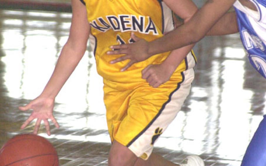 Kadena High School Panthers sophomore guard Dianne Abel (21) dribbles past Jocelyn Mosby of the Kadena Falcons base varsity women&#39;s team during Sunday&#39;s first-round loser&#39;s bracket double-elimination playoff game in the 13th Martin Luther King Pacificwide Open Basketball Tournament at the Foster Field House, Camp Foster, Okinawa.