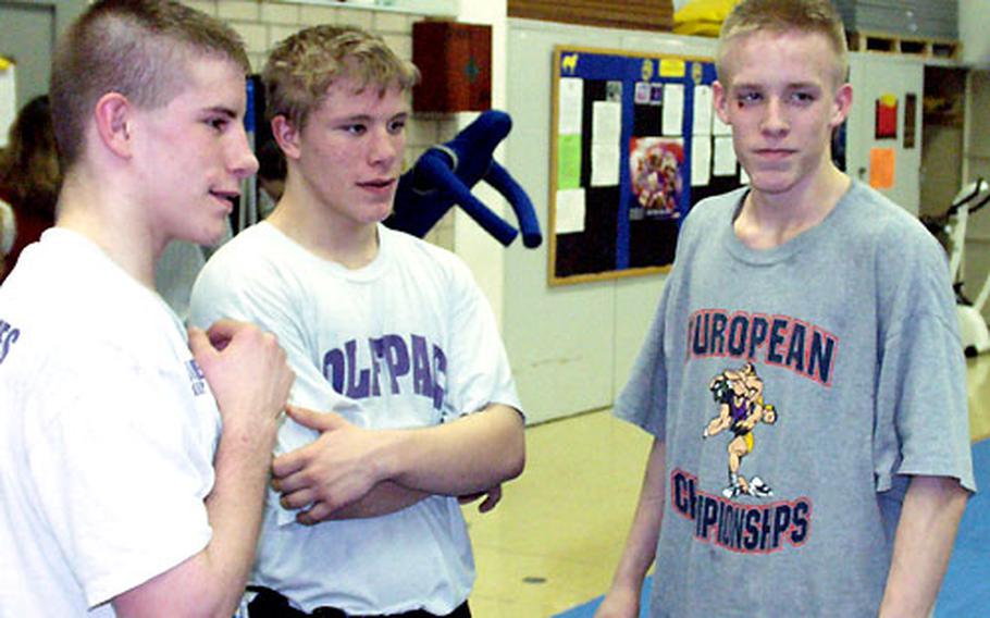 Würzburg wrestling brothers (from left) Jesse, Brian and Jonathan Painter pay close attention at practice.