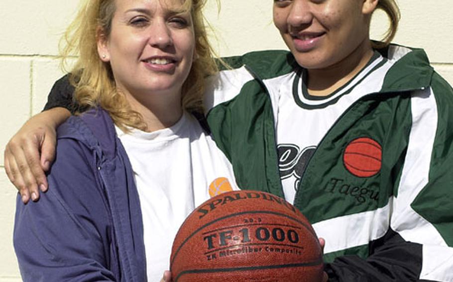 Coach Michelle Chandler and junior guard Ashley Gooch, mother-daughter combination for Korea&#39;s Taegu American Warriors in the 2004 Far East High School Girls Class A (small schools) Basketball Tournament at Pusan American School, Camp Hialeah, South Korea.