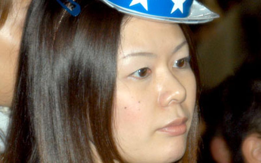 Fumie Kaneko wears a red, white and blue hat Tuesday night at the Yankees-Devil Rays game Tuesday night.