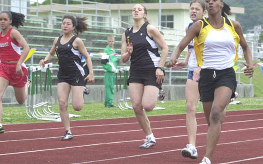 Teeny Henry, right, of the Kadena Panthers surges ahead of the field, including right to left Brittany Pafford of Morrison Christian Academy, Catherine Thornton and Eri Furukawa of American School In Japan and Jasmine Jordan of Nile C. Kinnick, in the girls 100-meter run Saturday in the 2nd Dr. Alva W. "Mike" Petty Memorial Track and Field Meet at Mike Petty Stadium, Kubasaki High School, Camp Foster, Okinawa.