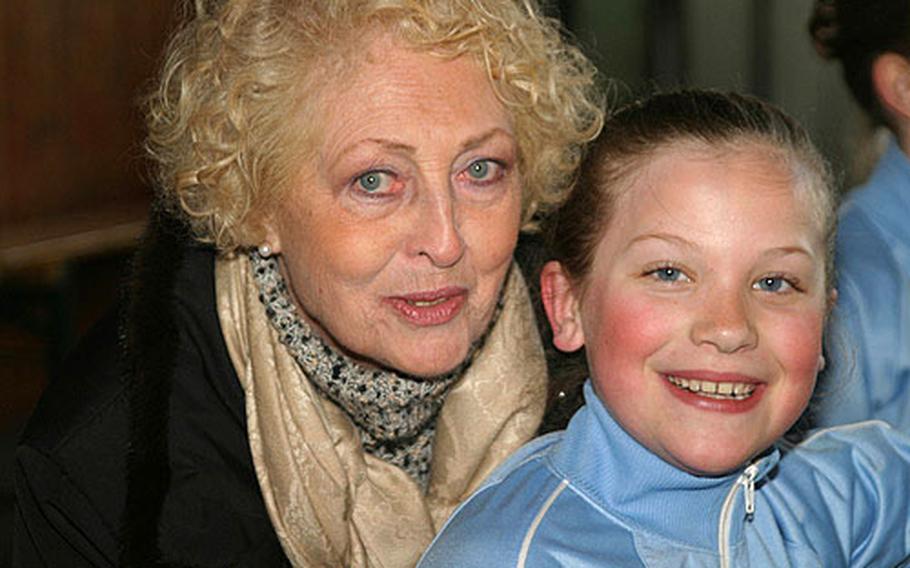 Michaela Arnold, left, a coach for the German ice skating club E.V. Bitburg, poses with 9-year-old Brianna Checkley, an American who recently won her age-group championship for the German state of Rheinland-Pfalz.