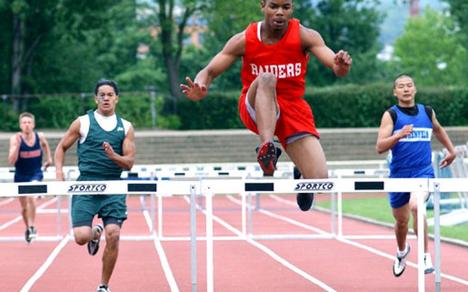 Gregory Thompson, of Kaiserslautern High School, sails over the final hurdle during the boys 300-meter intermediate event.