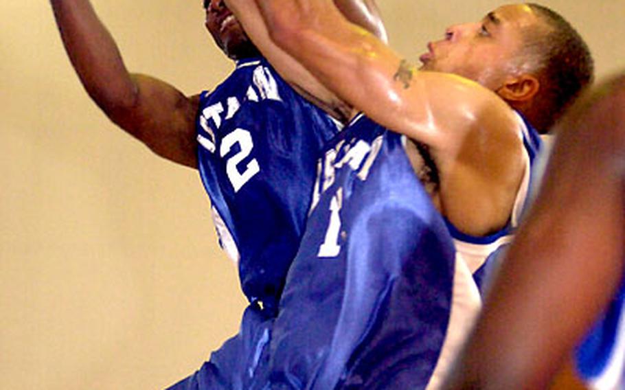 Lenard Tilley (2) and Justin Brown (13) of 1st Marine Aircraft Wing sky for a rebound against 3rd Marine Division /Expeditionary Force during Tuesday&#39;s round-robin play in the 2004 Marine Forces Pacific Regional Basketball Tournament. Wing downed Division 76-68.