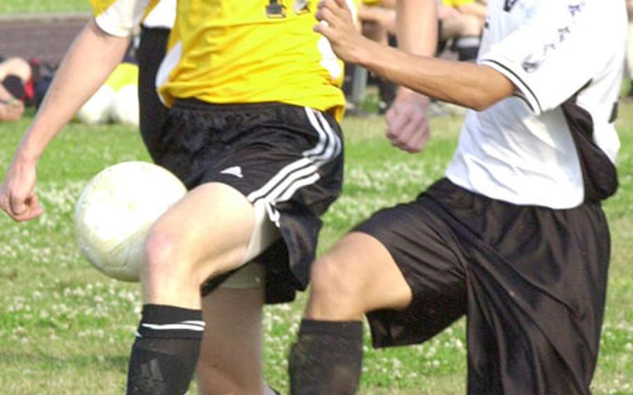 Kadena Panthers sophomore midfielder Nathan LaGrave, left, battling senior Chris Monroy of the Kubasaki Dragons for the ball.