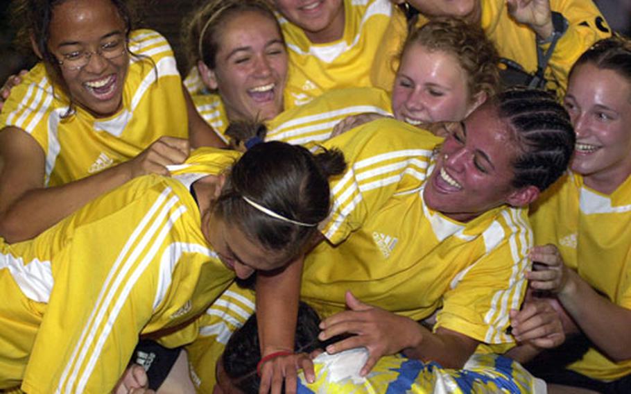 Members of the Kadena Panthers pile upon each other after Friday&#39;s championship match in the Far East High School Girls Class AA (large schools) Soccer Tournament at Trojans Field, Camp Zama, Japan.