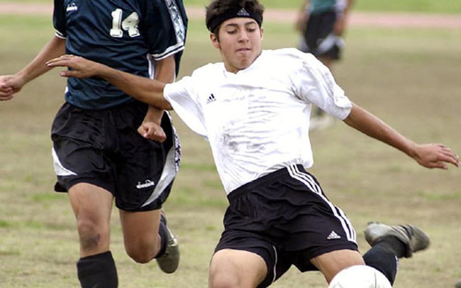 Aaron Zendejas, right, of the Kadena Panthers lines up a shot as Chris Monroy (14) of the Kubasaki Dragons watches during Friday&#39;s championship match in the Far East High School Boys Class AA (large schools) Soccer Tournament at Bonk Field, Yokota Air Base, Japan. Kadena won its second straight Class AA title 3-1 over Kubasaki.