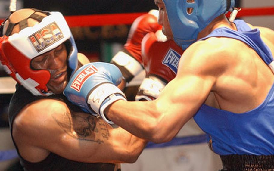 Ruben Almonte from Ansbach, Germany, left, and Raymond Myers from Hanau, Germany, exchange punches during the championship bout of the open 165-pound weight class at the U.S. Forces Europe Boxing Championships in Kaiserslautern, Germany, on Sunday.