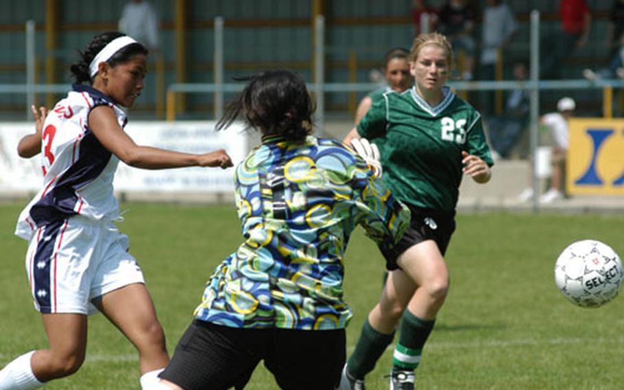 Aviano&#39;s Kassie Mangonsing gets the ball by both Naples goalkeeper Cara Wells and defender Tracy Light, but her shot went wide of the goal.