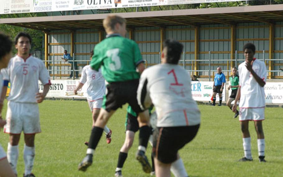 Naples&#39; Taylor Toombs collides with American Overseas of Rome goalkeeper Davide D&#39;Auria and the ball falls toward the ground. Toombs alertly kicked it into the net a few seconds later for his third goal of the day.