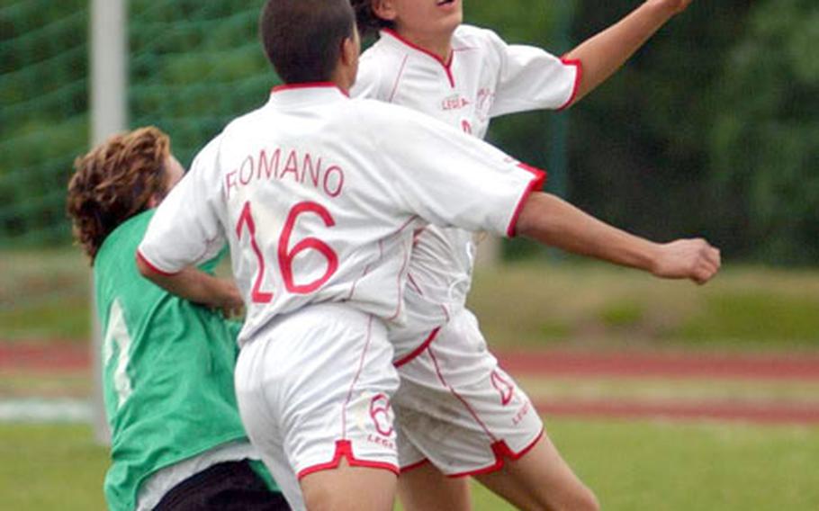 From left, Naples&#39; Daniel Rubia is knocked down by American Overseas School of Rome&#39;s Dario Romano as Juan Pablo Gomez Guarte heads the ball during the DODDS European Division III boys&#39; soccer championship in Kaiserslautern, Germany, on Friday.