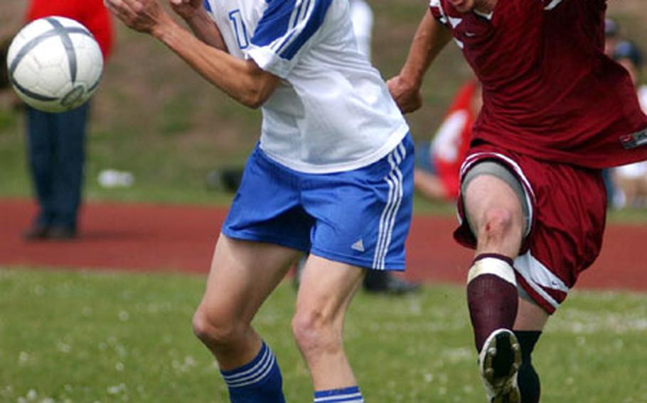 Vilseck&#39;s John Reilly, right, boots the ball past Black Forest Academy&#39;s Shawn Newby during the DODDS European Division II Boys Soccer Championship game at Ramstein, Germany, on Saturday.