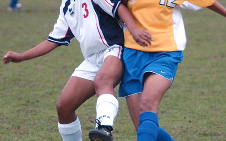 Aviano&#39;s Kasie Mangosing, left, wrestles the ball away from Ansbach&#39;s Kate Alegado in the DODDS European Division III Women&#39;s Soccer Championship in Kaiserslautern, Germany, on Friday.