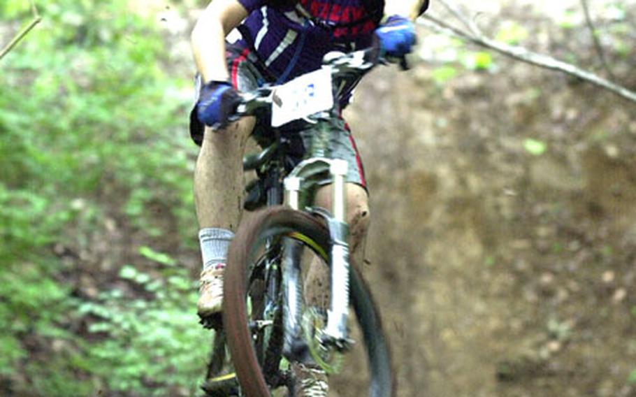 Nobuhisa Okada gets some air on the muddy trails of the Tour de Tama Saturday.