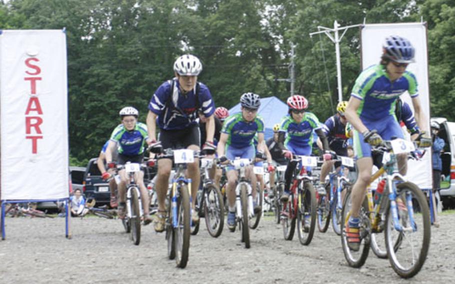 Mountain bike racers in the 14th Tour De Tama bike race shuffle for position Saturday at the Tama Hills Recreation Center, Japan. More than 70 American and Japanese riders took on the challenge of the steep muddy course for awards and prizes.