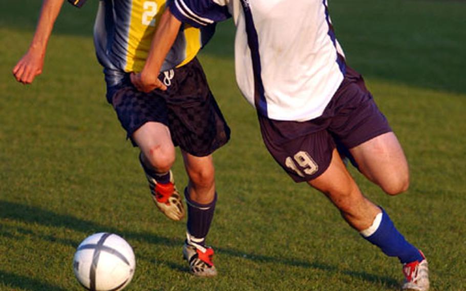 Heidelberg&#39;s Christoph Ascherl, right, and Wiesbaden&#39;s Collin Limes vie for ball possession during the Department of Defense Dependents Schools European Division I Boys Soccer Championship at Ramstein, Germany, on Saturday. Heidelberg broke a scoreless tie in the final minute to defeat the Warriors, 1-0.