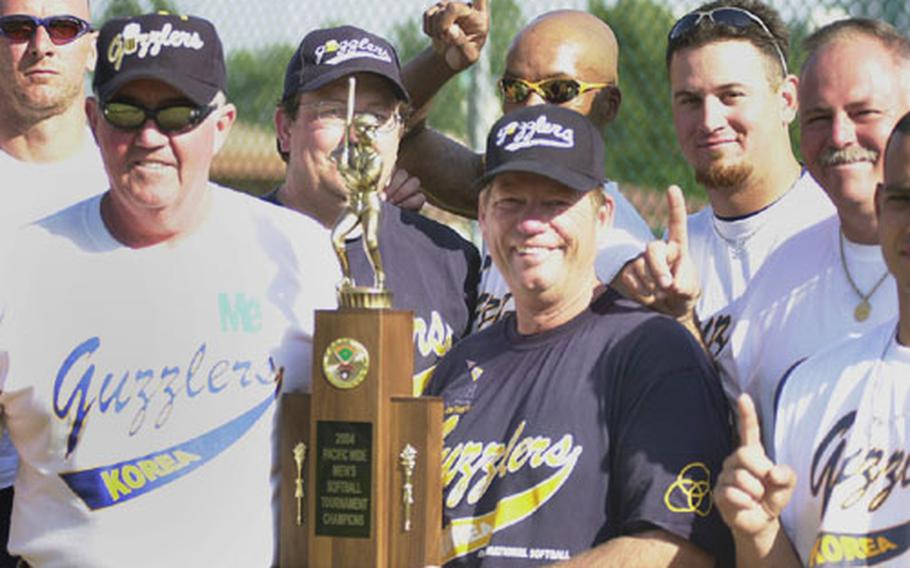 From left, Mike Sharp, head coach and team president Tom Costello, Billy Laxton, Tim Canty, assistant coach Bob Hochmuth, Jon Nicholson, Andy Watts and Jimmy Perez of Korea&#39;s International Guzzlers show off the first-place trophy after Monday&#39;s men&#39;s championship game in the 14th Pacificwide Open Softball Tournament.