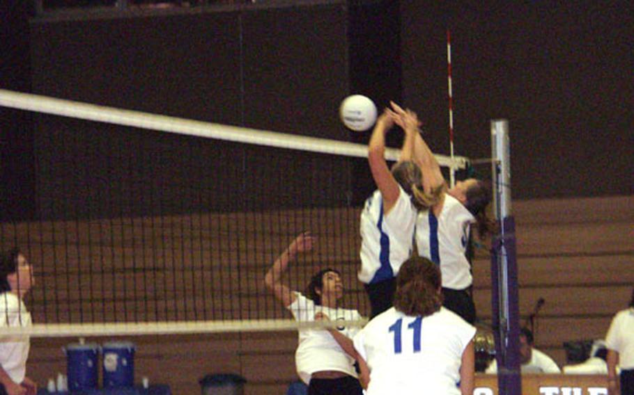 Lakenheath's Sara Dowell, right, and Nicole Stephenson make the block on a try from Bamberg's Merita Cagle during the Eagles' championship game victory Sunday at the 2004 U.S. Forces Europe volleyball tournament. Lakenheath's Tara Gilmore (11) watches the action.