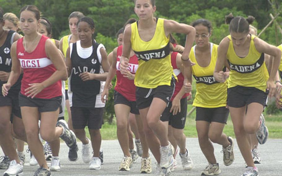 The pack of girls runners, led by defending Far East individual 3.1-mile race champion Kim Lyle, middle, begin Wednesday&#39;s Okinawa High School Athletic Association cross-country race at the 3.1-mile course at Kenney Park, Kadena Air Base, Okinawa. Lyle won for the second straight week with a time of 21 minutes, 34 seconds. Lyle, Kadena High School senior and winner of the 2002 Far East Cross Country individual 3.1-mile race, signed a letter of intent Wednesday to run for Stetson, an NCAA Division I school in Deland, Fla.