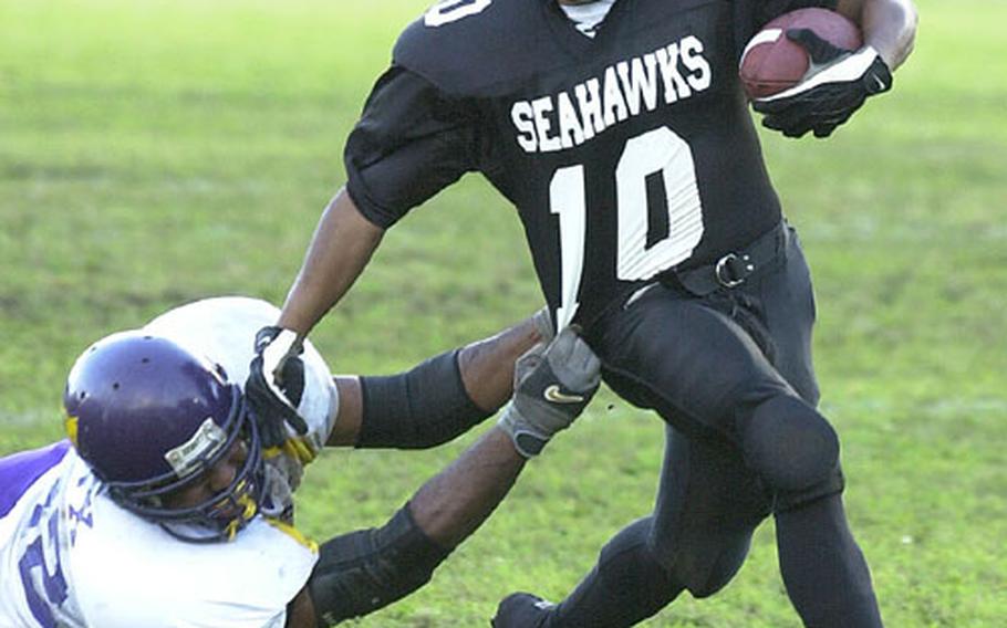 Yokosuka Seahawk Demarious Franklin (10) sheds the tackle of a Misawa Marauders defender during Saturday&#39;s U.S. Forces Japan-American Football League game at Ikego Heights Naval Housing Facility, Japan. The four-time defending champion Seahawks won 18-12 in four overtimes.