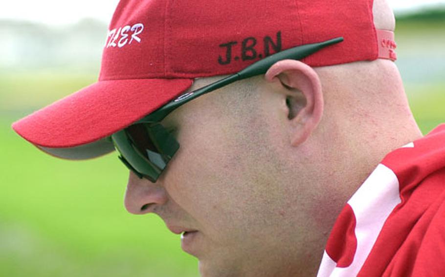 Coach Kip Hogan of Marine Corps Base Camp Butler wears a cap bearing the initials JBN on the side. Those are for Jamie Newberry, who coached the team the past couple of years and who died July 25.