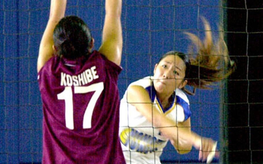 Yokota Panthers junior outside hitter Shiori Kaneko spikes the ball against Seisen International Phoenix senior middle blocker Yuri Koshibe (17).