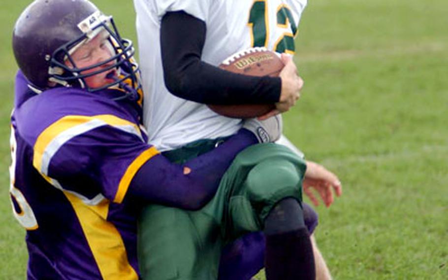 SHAPE quarterback Sean Corcoran, right, is tackled by Mannheim’s Ryan Smith on Saturday in Mannheim, Germany. SHAPE defeated Mannheim 36-0 and improved to 3-1.