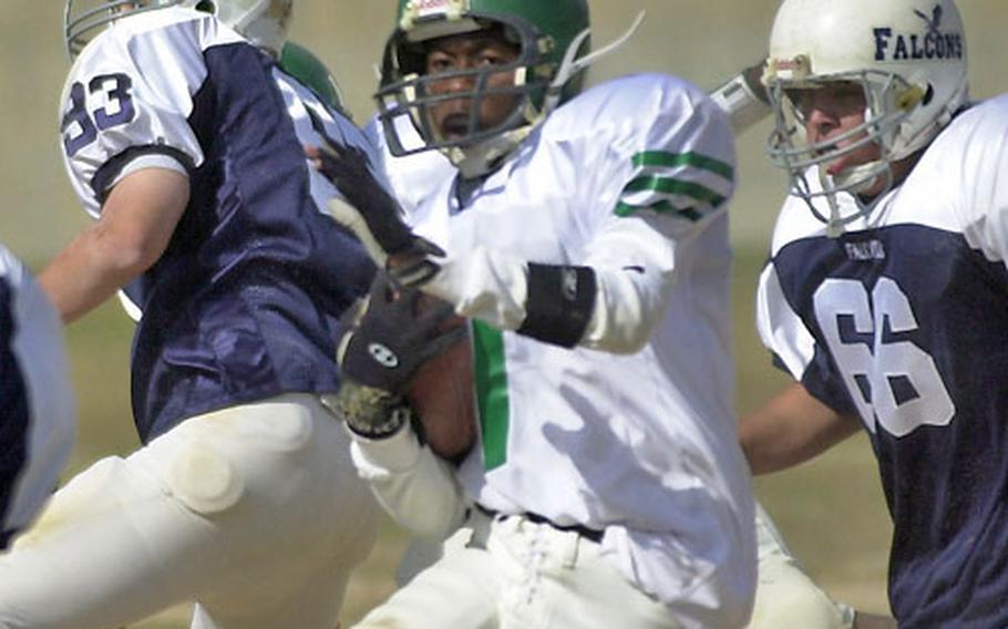 Taegu American sophomore Sidney Washington tries to weave his way through the Seoul American defense during the first quarter of Saturday&#39;s game.