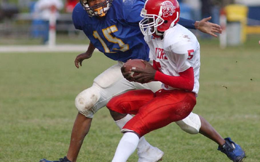 Kaiserslautern quarterback Danny Morris, right, is flushed out of the pocket and tackled by Wiesbaden&#39;s Shannon McCray during Saturday&#39;s game.