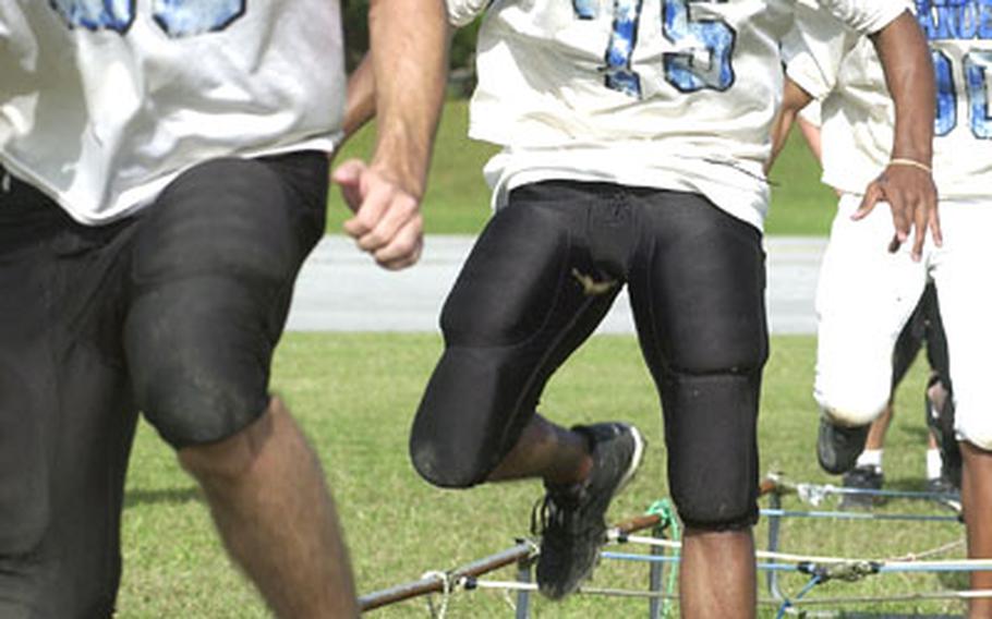 Kadena Islanders players perform a rope agility drill during a practice Wednesday at Kadena High School&#39;s lower practice field on Kadena Air Base, Okinawa. The Islanders, 5-0 so far this season, host the Kubasaki Samurai in the Okinawa Activities Council regular-season finale on Friday.