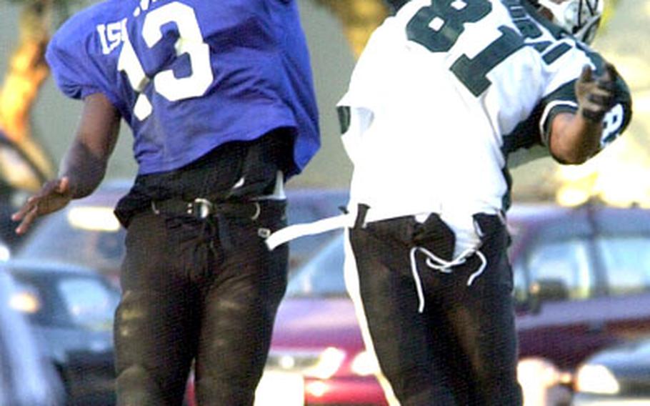 Kubasaki Samurai receiver Stephen Thompson (81) and Kadena Islanders cornerback Keith Loving (13) go up for a pass in Friday&#39;s game. Thompson had 112 yards and two TDs on eight catches and Loving ran 21 times for 223 yards and two TDs.