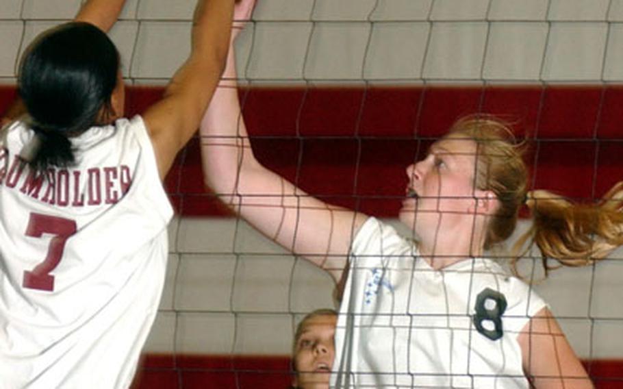 Baumholder&#39;s Kandace Dyer, left, blocks a shot by Ansbach&#39;s Alison Hazen during a DODDS high school volleyball match in Baumholder, Germany, on Saturday.