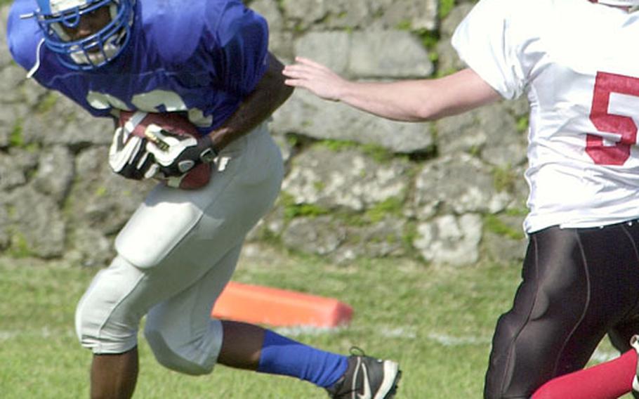 Schwab receiver Jermaine Parlow (29) catches an 18-yard fourth-quarter touchdown pass just out of the reach of Foster-Futenma defender Joshua Wilson (5) during Saturday&#39;s Okinawa Football League game at Courtney Bowl, Camp Courtney, Okinawa.