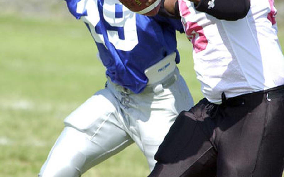 Schwab Panthers defender Jermaine Parlow (29) draws a bead on Foster-Futenma Bulldogs tight end Tracey Devero.