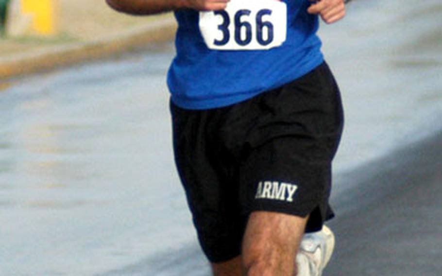 Army Cpl. Curtis Persinger from the 1103rd Military Police Battalion at Camp Babylon takes a commanding lead in the Army Ten-miler at LSA Anaconda Sunday. Persinger won in a time of 56:02.