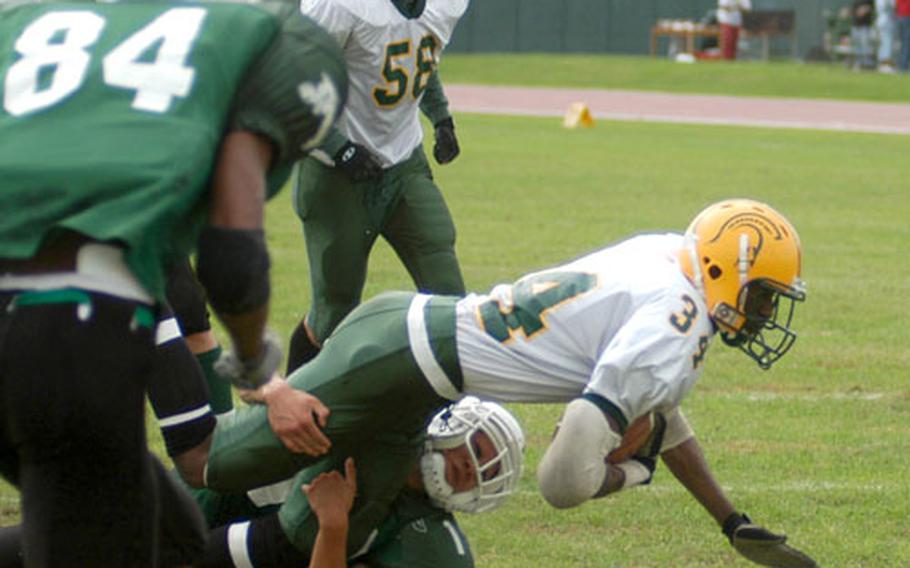 SHAPE running back Steven Small dives into the end zone with a Naples defender in tow.