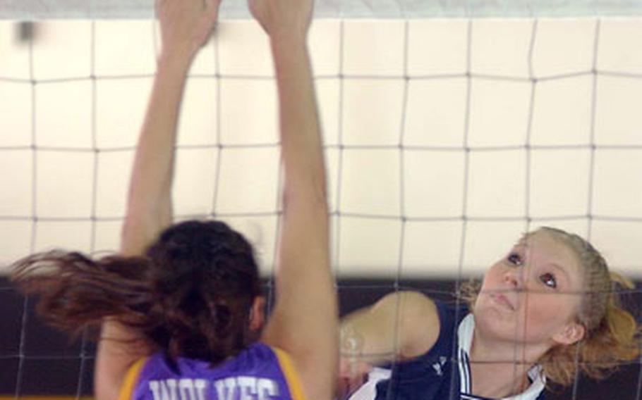 Lakenheath’s Ashley Lariviere, right, slams a ball past Würzburg’s Tiffany Chalupa on Friday.