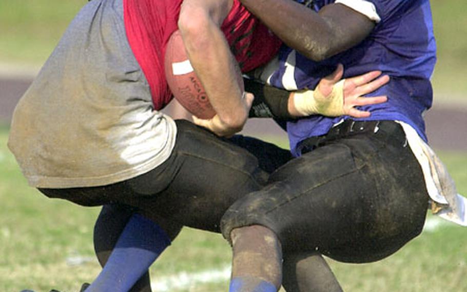 Islanders defensive end David Willkins, right, wrestles Buccaneers quarterback Tyler Schmidt to the ground during Friday&#39;s game.