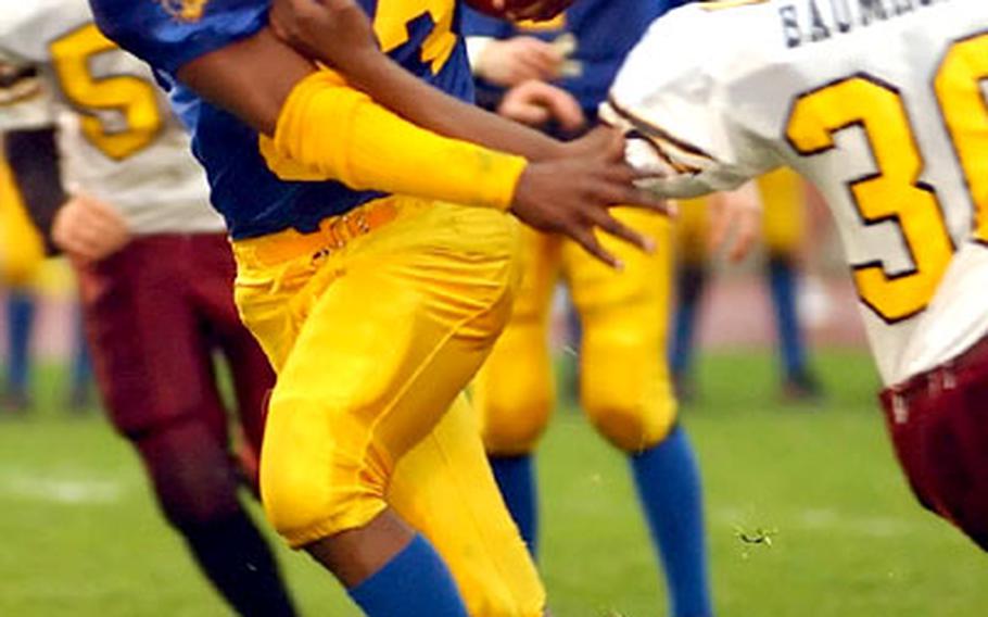 Ansbach&#39;s Dameon Outley breaks the tackle of Baumholder&#39;s T.J. Whatley.