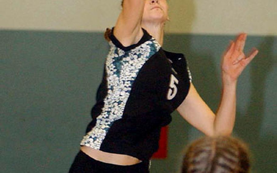 Alconbury&#39;s Katie Schonder leaps high for a spike in the Dragons&#39; 25-20, 20-25, 25-22, 25-16 Division IV win over Milan on Saturday. In the foreground are her teammates Aja Brown, left, and Carly Bascom.