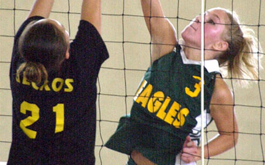 Senior outside hitter Arlie Boera of Japan&#39;s Robert D. Edgren Eagles goes up to spike through the block of freshman Demi Sanchez of Guam&#39;s George Washington Geckos during Monday&#39;s pool play in the 2004 Far East High School Girls Class AA Volleyball Tournament. GW won 25-13, 25-23.