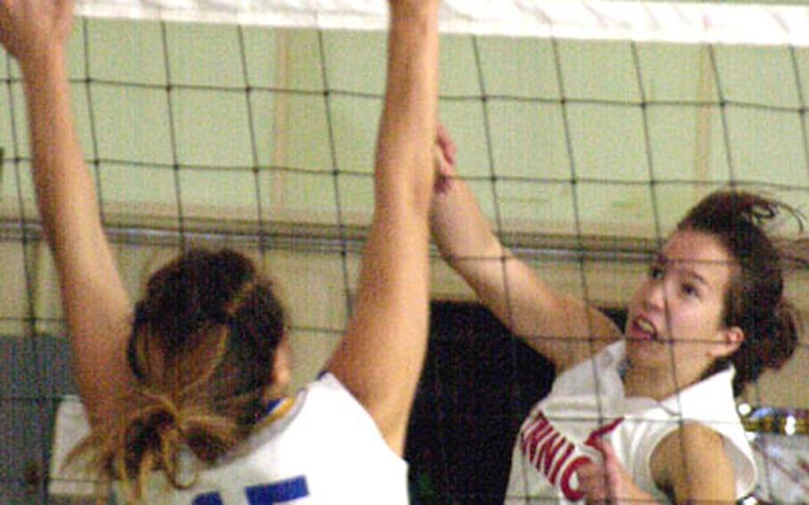 Nile C. Kinnick junior Erica Niemeyer smacks a spike past the block of Yokota senior Rachel Wright during Tuesday&#39;s Silver Division play in the 2004 Far East High School Girls Class AA (large schools) Volleyball Tournament at Kubasaki High School, Camp Foster, Okinawa. Yokota beat Kinnick for the third time this season 26-24, 25-13.