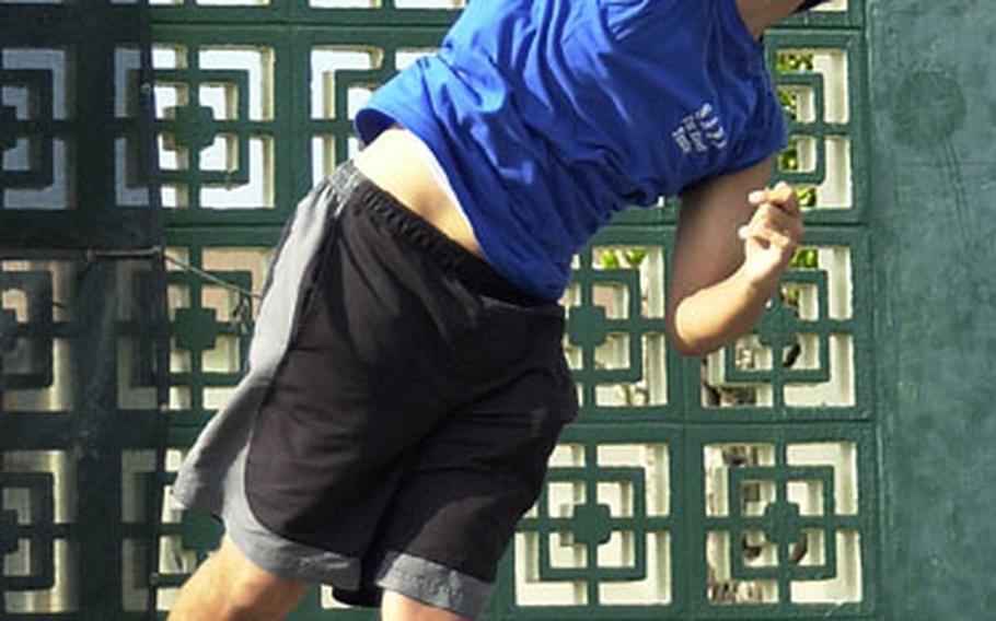 Chris Suh of the Seoul American Falcons serves during Thursday&#39;s mixed doubles match. Suh teamed with Jane Chai to beat Mark Bote and Lara Deguzman of Japan&#39;s E.J. King Cobras 6-4, 6-3.