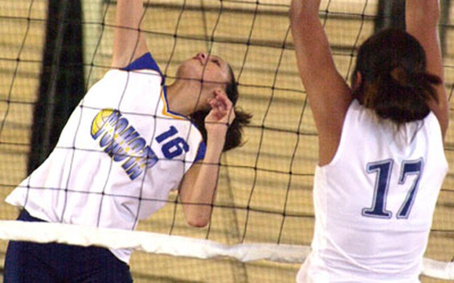 Yokota Panthers senior outside hitter Jonica Childress (16) prepares to spike past Academy of Our Lady Cougars middle blocker Cassandra McFadden (17) during Thursday&#39;s quarterfinal. Defending champion Academy of Guam swept Yokota 25-23, 25-12, 25-20.