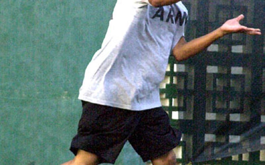 Junior James Edwards of Pusan American smashes a forehand return against Allen Chin of Seoul American during Friday&#39;s boys singles championship. Edwards beat Chin 6-2, 6-3.