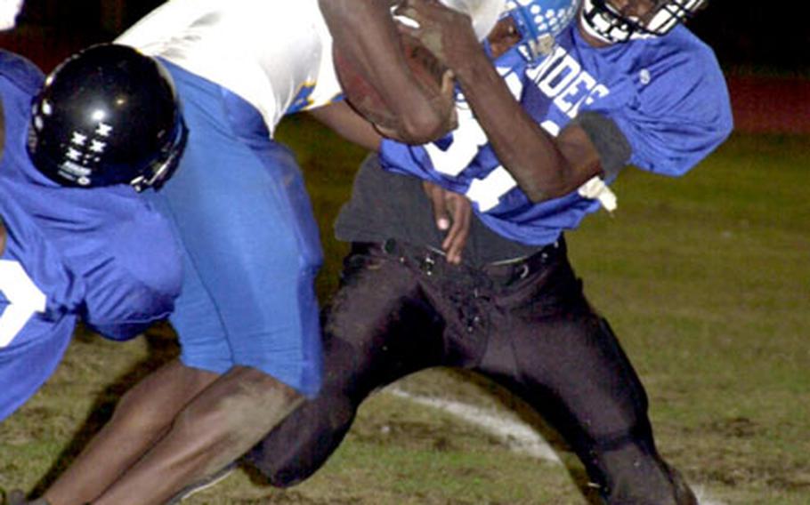 Yokota Panthers receiver D.J. McCary bulls past Kadena Islanders defender Arnold "Spex" Tillman into the end zone.